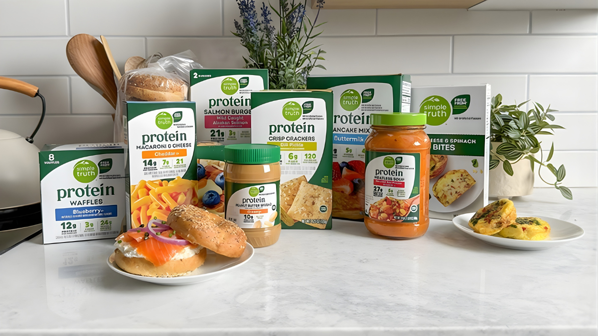Simple Truth Protein packaged foods including waffles, mac and cheese and snacks displayed on a kitchen counter.