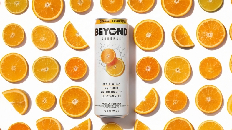 Beyond Meat plant-based protein drink can with sliced oranges on white background