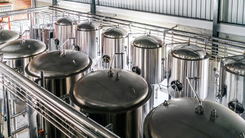 Industrial stainless steel fermentation tanks in food production facility